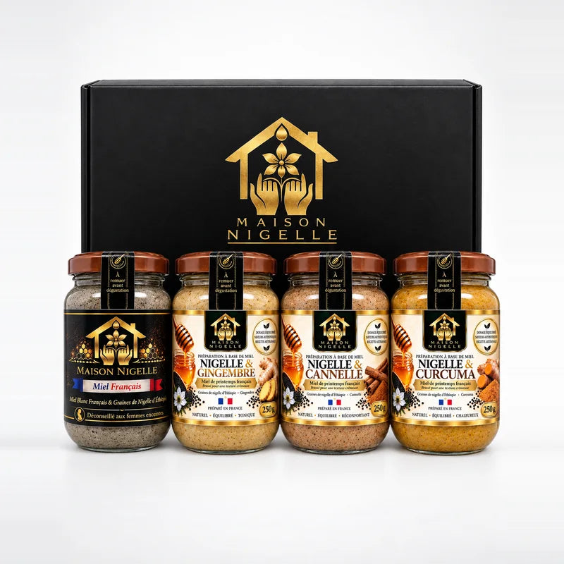 Coffret noir Maison Nigelle et ses quatre pots de 250 g de miel au nigelle alignés devant